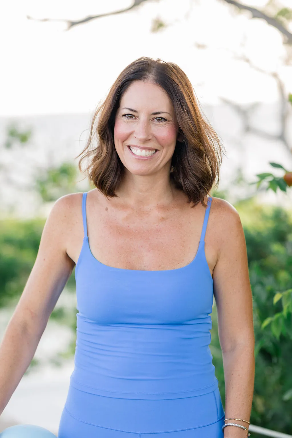 Coastal Sculpt co-founder smiling by the harbor